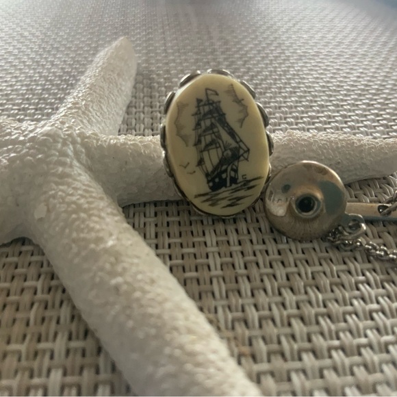 Vintage scrimshaw tie tac with a tall sailing ship.